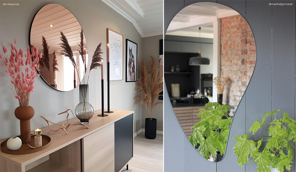 Růžově zlaté kulaté zrcadlo na šedé stěně - kapkovité zrcadlo na šedé stěně